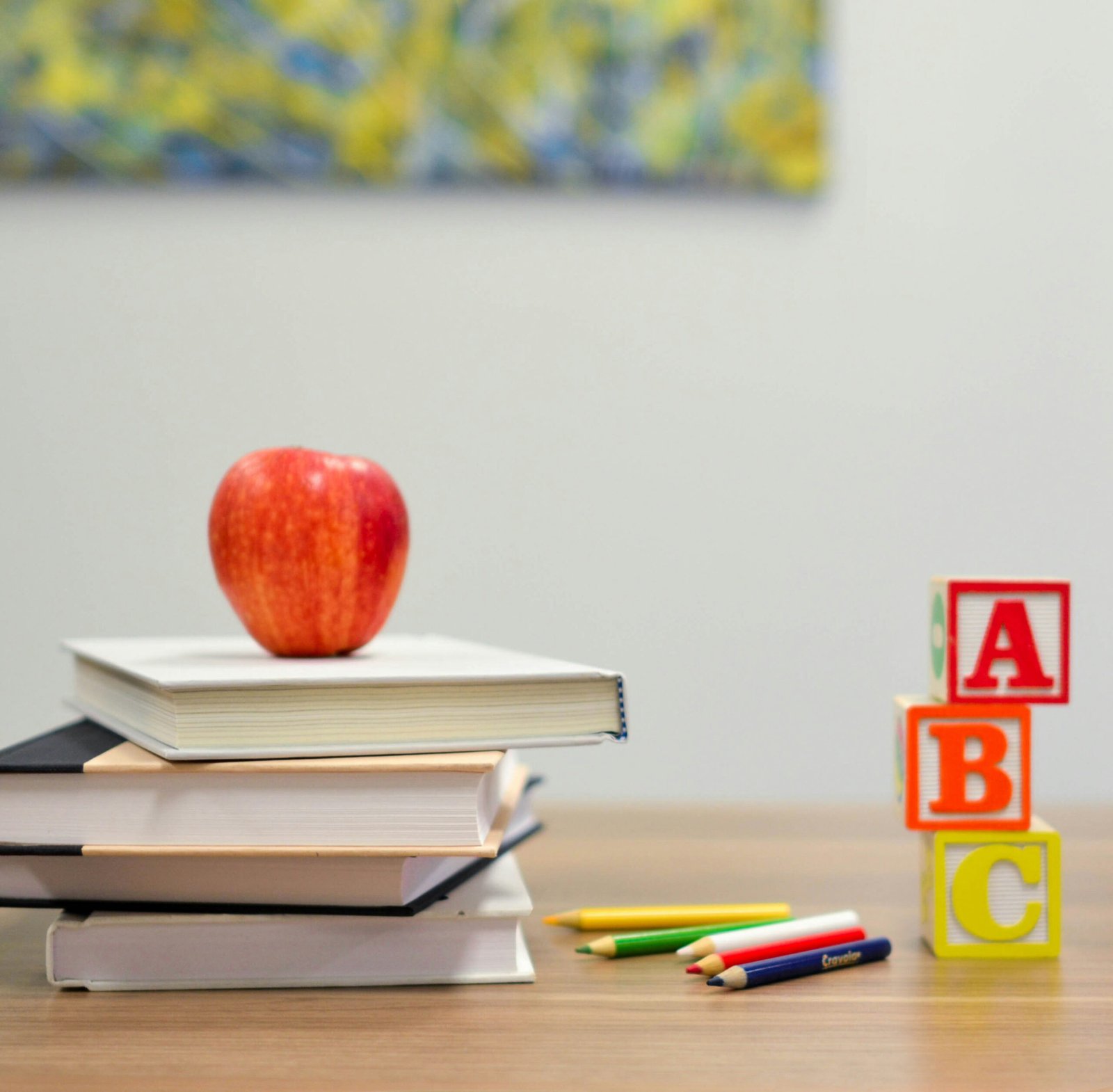 Books, letter blocks and apple cover image